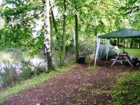 A gazeebo on the far bank provides shade at Genets carp lake in France. 
