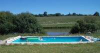 The swimming pool overlooks the lake at Notaires carp lake in France. 