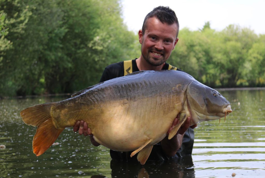 lillypool carp lake in france with log cabin